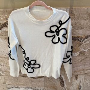 White flowered sweater
